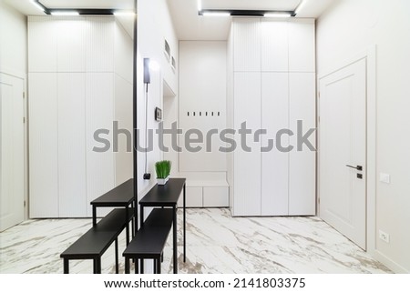 new interior with white walls, large mirror and ferrous metal