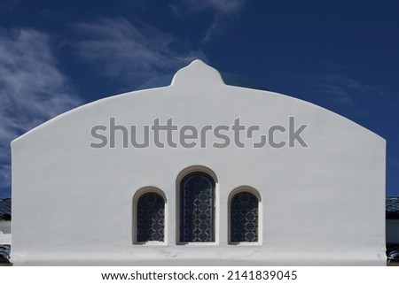 Back side of an orthodox church in Santa Barbara under blue sky