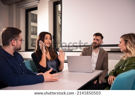 A rude business woman answers the call during business meeting Royalty-Free Stock Photo #2141850503