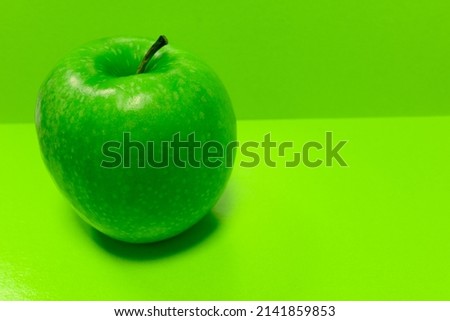Green apple on a light green background