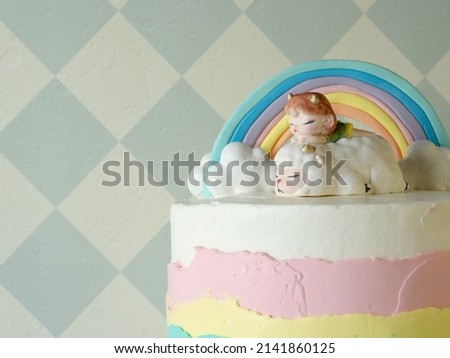 figurine made of mastic in the form of a beautiful little girl on a sheep, clouds and a rainbow. for the birthday cake