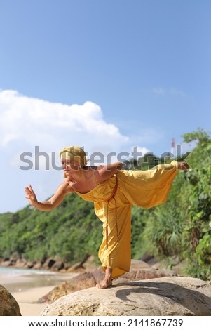 Healthy life exercise concept.Beautiful female doing yoga  at the beach 