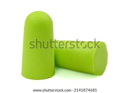 Light green ear plugs isolated on a white background.Close-up.Soft foam earplug
