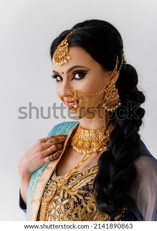 Portrait of beautiful indian girl. Young India woman model with jewelry set. Traditional Indian costume sari.