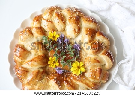 Festive Homemade spring flower challah bread glazed with honey and sugar for Rosh Hashanah (Jewish New Year Holiday) and special occasions against white background, copy space