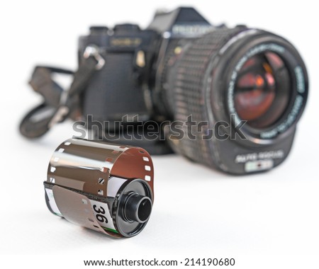 Vintage camera with a 35mm film on a white background. 