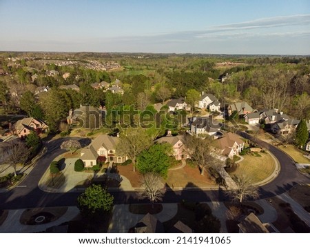 Aerial panoramic view of house cluster in a sub division in Suburbs with golf course in metro Atlanta in Georgia ,USA shot by drone shot during golden hour