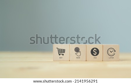 Buy now pay later BNPL online shopping concept. Online shopping, internet retail and e-commerce. Customer service, net payment terms. Wooden cubes with BNPL abbreviation, symbols on smart background. Royalty-Free Stock Photo #2141956291