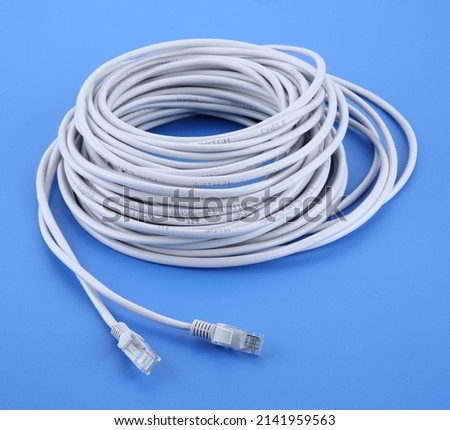 Internet data cable isolated on white background. LAN cable patch cord. Network internet cable isolated over blue. 