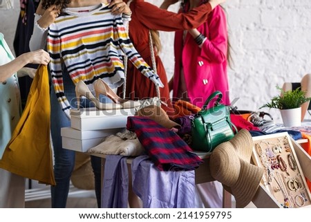 Young women at swap home party - clothes, shoes, bags, jewellery exchange between friends. Zero waste shopping, eco friendly concept, sustainable lifestyle. College life.  Royalty-Free Stock Photo #2141959795