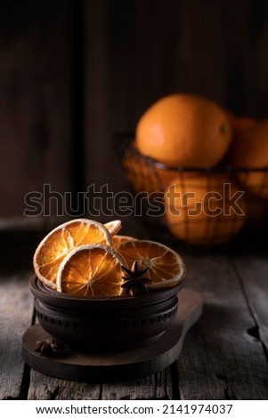 Orange chips in a wooden bowl on the table close-up.