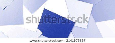 Panoramic background of blue paper sheets. Many sheets of blue paper