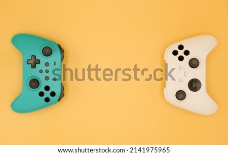Joysticks gaming controller isolated on pastel yellow background, Video game console developed Interactive Entertainment Royalty-Free Stock Photo #2141975965