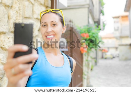 Tourist in yellow glass smile and taking selfie