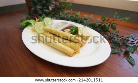 Photo of cheese roll on a plate with two kinds of sauce