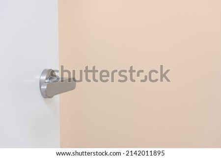 Open white door and orange background
