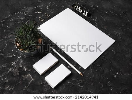 Photo of blank stationery set on black plaster background. Stationery template for branding identity for designers.
