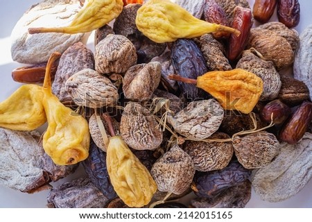 Top view of delicious dried figs, pears and dates, panoramic shot. dried fig background.