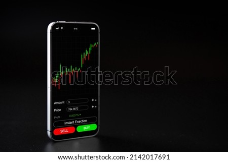 Crypto currency trading. Pink piggy bank, gold crypto currency BTC bitcoin, bitcoin wallet mobile phone application on black background. Save virtual money concept