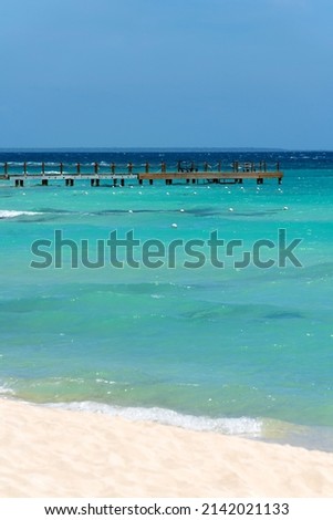Long wooden pier going out to sea. Beautiful seascape in the caribbean in the Dominican Republic. High quality photo