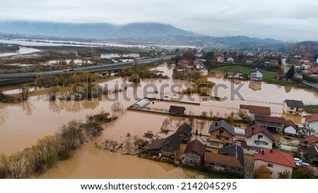 Aerial drone view of torrential rain causes flash floods in residential areas. Houses and roads surrounded by water. Climate change. Heavy rainfall consequences. 
 Royalty-Free Stock Photo #2142045295