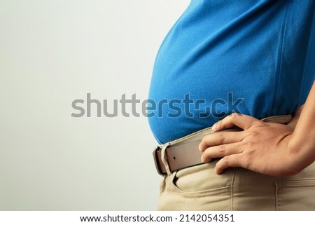Fat man has excess fat, he is dieting and losing weight. Royalty-Free Stock Photo #2142054351