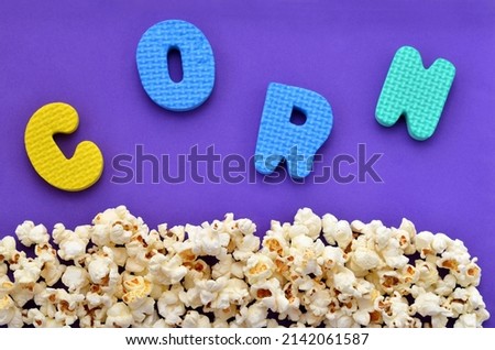 sprinkled popcorn on a blue background and the inscription corn