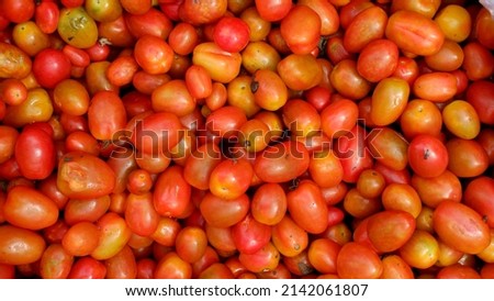 Stacked tomatoes cherry in traditional market, tomatoes cherry background 