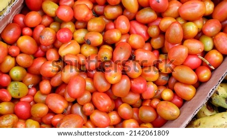 Stacked tomatoes cherry in traditional market, tomatoes cherry background 