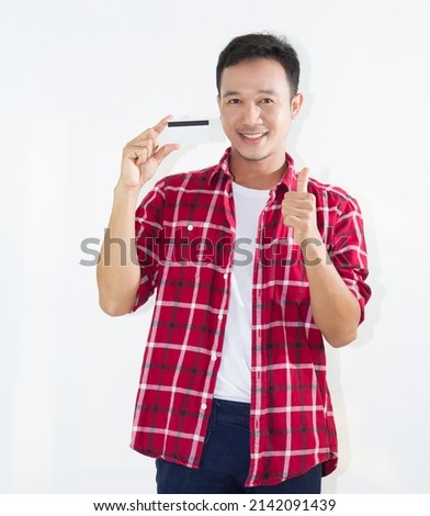 Portrait of Happy asian man holding credit card and smiling