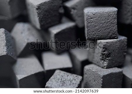 Charcoal for hookah. charcoal for hookah in the form of cubes. Coal for hookah in the form of a cube. The texture of cubes of coal close-up. Royalty-Free Stock Photo #2142097639