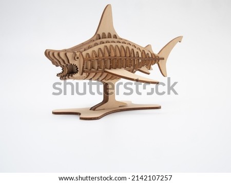 shark-shaped plywood toy on a white background