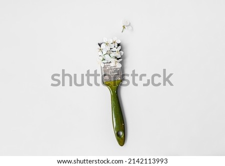 paint brush with spring flowers. creative drawing concept. Spring. bloom. copy space. place for text. on a gray background