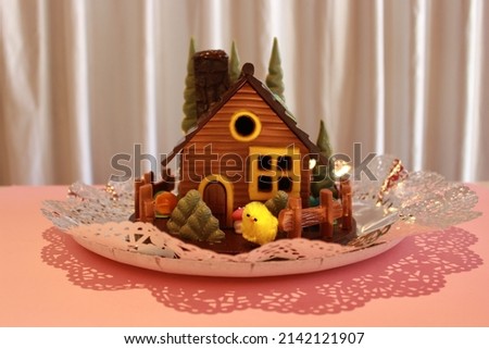 Chocolate figure in the shape of a house to celebrate the Easter party or Christmas. Tradition of Catalan and Spanish culture. Sweet and delicious desserts for kids and children.