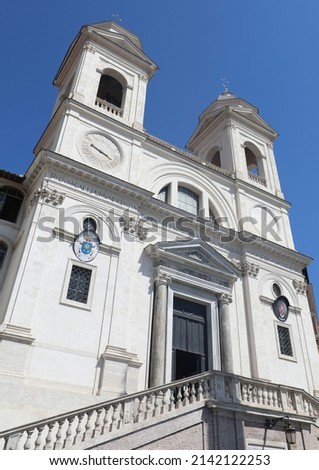 Trinita dei Monti church in Rome viewed from below with no people and blue sky in the background