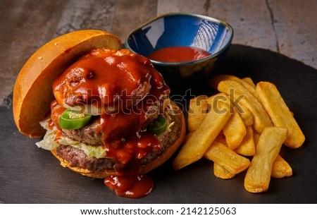 top view hamburger with fries onion chili with meat and jalapenos barbecue sauce dark style food