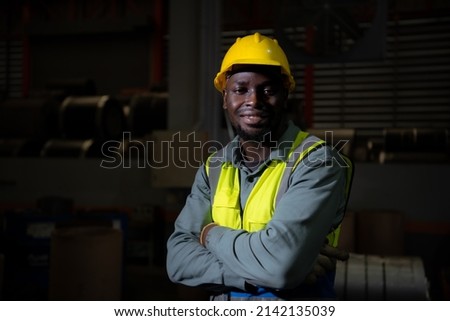 Portrait of heavy industrial workers working at night.