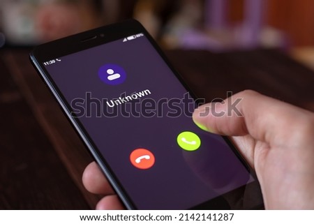 Unknown number calling. Phone call from stranger. Unexpected call disturbs at night. All screen graphics are made up Royalty-Free Stock Photo #2142141287