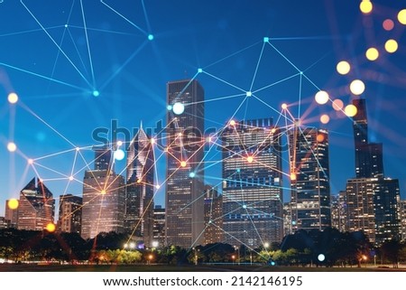 Chicago skyline from Butler Field to financial district skyscrapers, night time, Illinois, USA. Parks and gardens. Social media hologram. Concept of networking and establishing new people connections