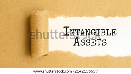 Intangible assets. text on white paper over torn paper background. Royalty-Free Stock Photo #2142156659