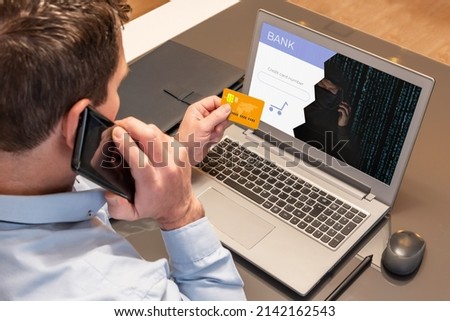 Man making purchases with his credit card over the phone while being scammed by a cyber thief. Vishing scam Royalty-Free Stock Photo #2142162543