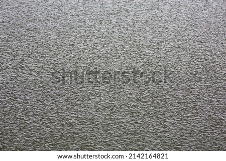 Water surface hit by raindrops