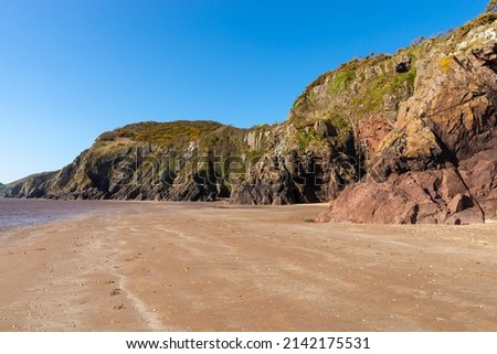 Cliff walls on the Scottish coast.  Sandyhills Beach, Dalbeattie, Scotland. Royalty-Free Stock Photo #2142175531