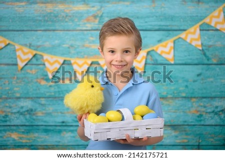 A young boy and decorations for Easter. Studio background.