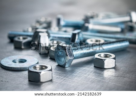 Working tool. Nuts and bolts on the table. On a gray background. High quality photo