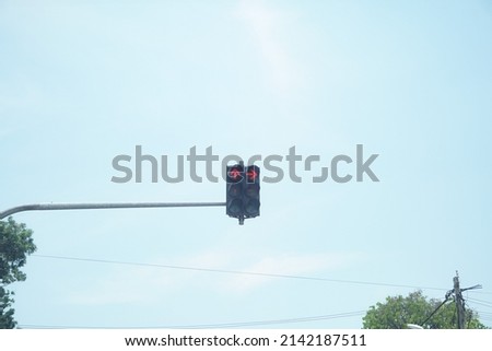 Traffic light with red color on sky background.