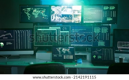 Control room monitoring surveillance video camera control city - Empty space dark room office full of screen device from secret service public safety computer station center. No people indoors.  Royalty-Free Stock Photo #2142191115