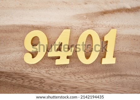 Wooden  numerals 9401 painted in gold on a dark brown and white patterned plank background.