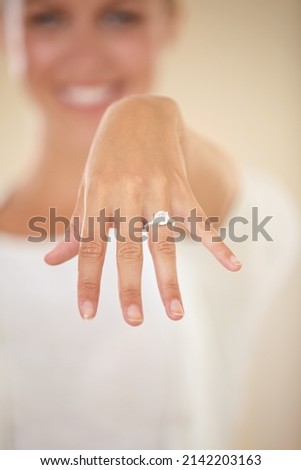 Were tying the knot. Cropped shot of a young woman showing off her engagement ring. Royalty-Free Stock Photo #2142203163