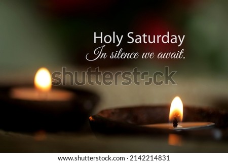 Holy Saturday concept with candle light in a traditional ceramic bowl and text quote - In silence we await. Happy Holy Saturday, the holy week before Easter. Royalty-Free Stock Photo #2142214831